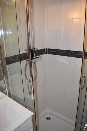 une salle de bain avec une douche avec une porte vitrée dans l'établissement Charmant logement de 25m2 dans maison de Pays, à Les Vigneaux