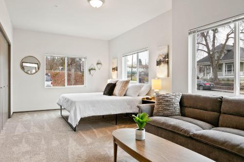 a living room with a couch and a bed at HUGE-Fun-Trendy Apt by Perry District & Downtown in Spokane