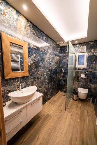 a bathroom with a sink and a mirror at Thomas Villa Hersonissos - Private Pool - Sleeps 7 in Hersonissos