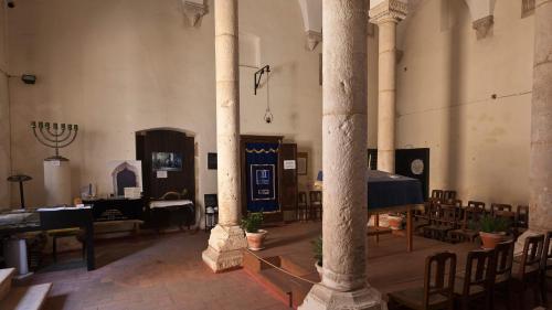 a large room with tables and chairs in a church at Bairro das Flores in Tomar