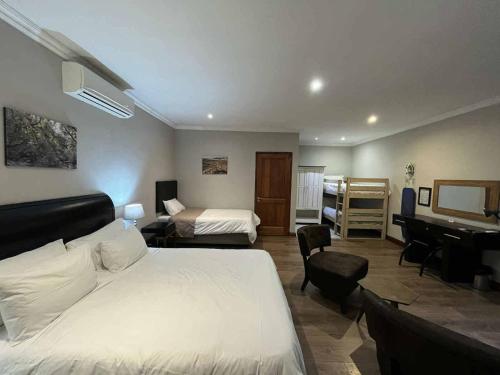 a hotel room with a bed and a desk at ilanda Guest House in White River