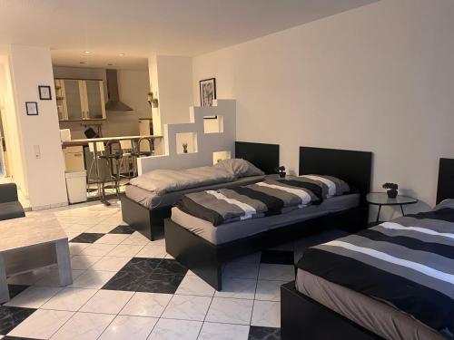 a room with two beds and a living room at casabella in Leverkusen