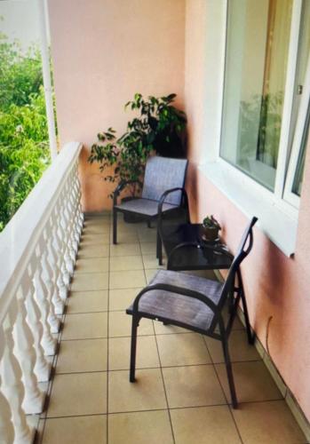 two chairs sitting on a balcony with a window at Apartments in Umanʼ