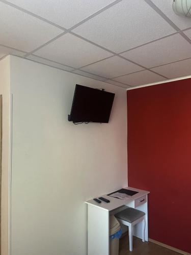 a room with a desk and a tv on a wall at Ubytování Niagara in Třebíč