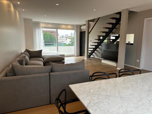 a living room with a couch and a table at Purobaires Hotel Boutique in Buenos Aires