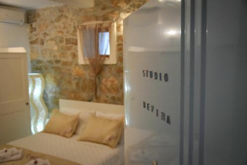 a living room with a couch and a refrigerator at Apartments Bepina in Split