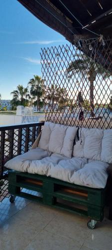 a bed sitting on top of a balcony at Apartamento 309 frente al mar en Alcossebre in Alcossebre