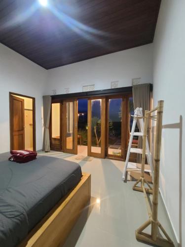 a bedroom with a bed and a ladder in it at Batur Volcano Basecamp in Kubupenlokan