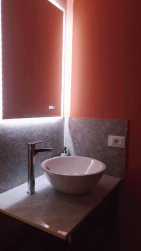 a sink in a bathroom with a mirror at Casa Villaggio Pirandello in Agrigento