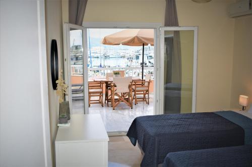 a bedroom with a bed and a table with an umbrella at Christina's apartment 2 in Kontokali