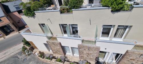 an overhead view of a white building with windows at Hotel De L'Europe in Perros-Guirec