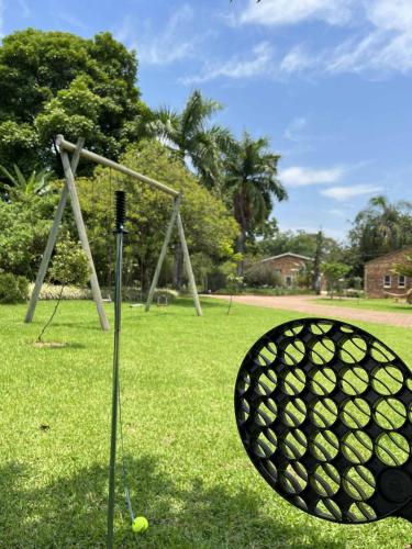 a golf ball in the grass next to a swing at ilanda Guest House in White River