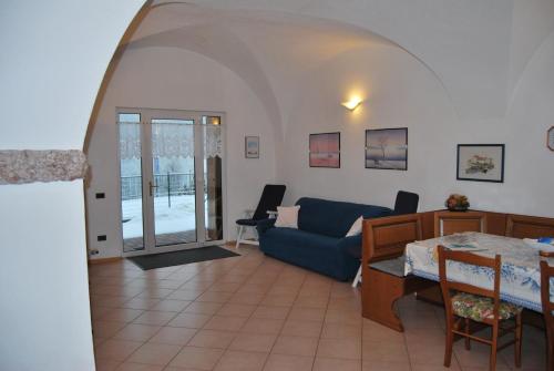 a living room with a blue couch and a table at Residenza Arnica in Molveno
