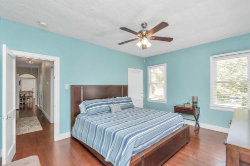 a bedroom with a bed and a ceiling fan at Cozy Historic Galveston House-8 min walk to beach! in Galveston