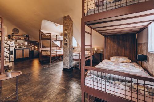 a room with two bunk beds and a table at Q PODGORICA Beds,Rooms and more in Podgorica