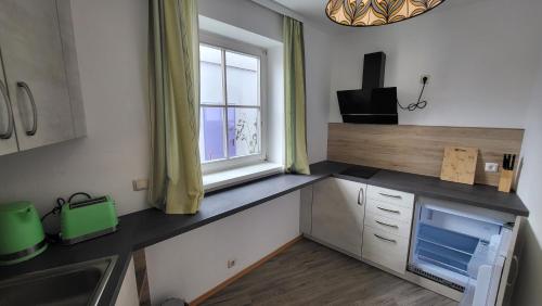 a kitchen with a counter top and a window at Gasthof Moser in Fohnsdorf