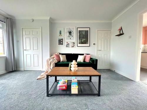 a living room with a couch and a coffee table at Quirky, Family Home in Glasgow in Cardonald