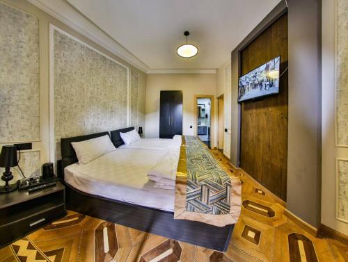 a bedroom with a large bed in a room at La Casa Hotel Yerevan in Yerevan