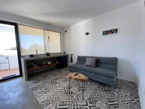 a living room with a couch and a table at Casa Naâmja in Tepoztlán
