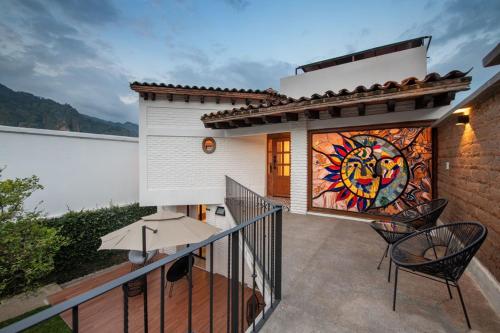 a balcony of a house with a mural on the wall at Casa Naâmja in Tepoztlán