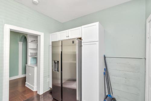 a kitchen with a refrigerator in a room at Historical Galveston House - 2 min drive to sand!! in Galveston