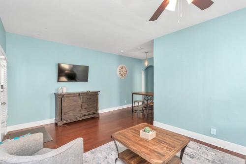 a living room with blue walls and a table at Historical Galveston House - 2 min drive to sand!! in Galveston