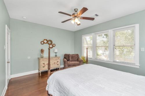 a bedroom with a bed and a ceiling fan at Historical Galveston House - 2 min drive to sand!! in Galveston