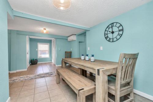 a dining room with a table and a clock on the wall at Galveston Studio - Sleeps 7 - Minutes to Beach !! in Galveston
