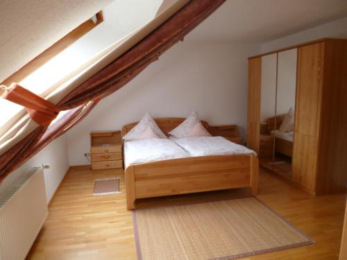 a bedroom with a bed and a large mirror at Haus Götterlay in Bruttig-Fankel