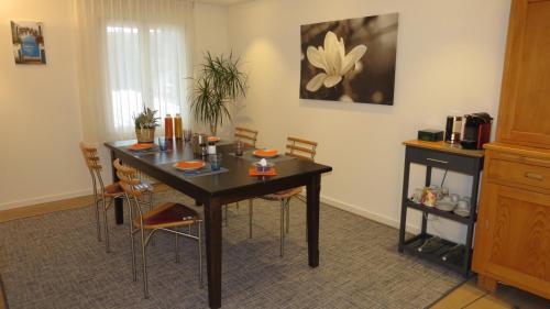 a dining room with a table and chairs at Dorf-Schmiede - Bed und Breakfast in Müllheim