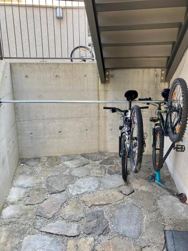a bike parked in a room with a wall at MarAvilia Apartment - vicino a Splash & SPA Tamaro in Monte Ceneri