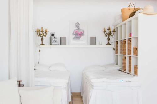a room with white furniture and white walls at Regina's Banyuls - Mountain view in Banyuls-sur-Mer