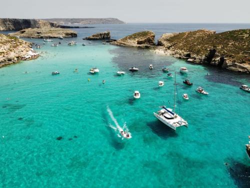 an aerial view of a beach with boats in the water at Escape to St Julians in St. Julianʼs