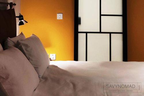 a bedroom with a bed with white sheets and pillows at Crew 2 Savynomad Harbour Residences wow Views in Cospicua