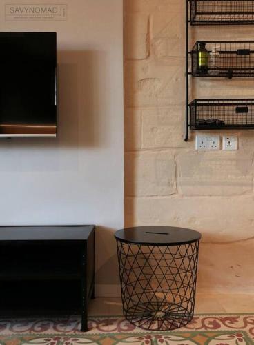 a living room with a table and a wall with a tv at Crew 2 Savynomad Harbour Residences wow Views in Cospicua