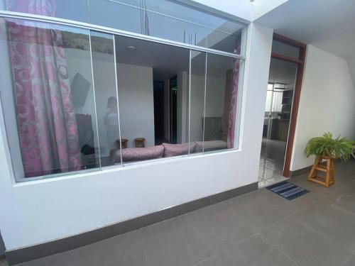 a room with a large window with a potted plant at Apartamento/Departamento independiente nuevo in Tacna