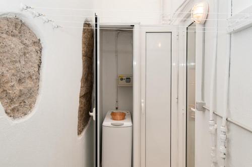 a bathroom with a toilet in a glass door at Beach Apartment M&B in Las Palmas de Gran Canaria