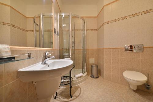 a bathroom with a sink and a toilet at City Hotel Morris in Česká Lípa