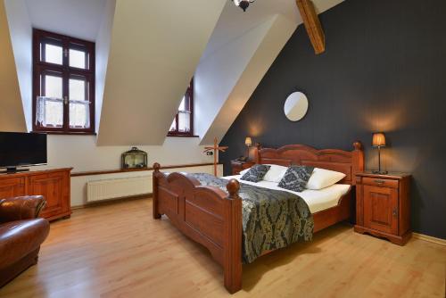 a bedroom with a bed and a television in it at City Hotel Morris in Česká Lípa