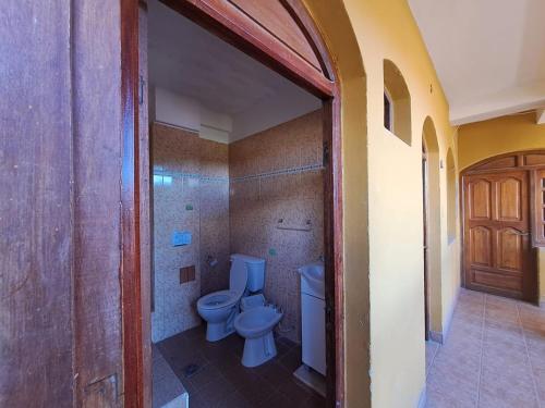 a bathroom with a toilet and a sink in it at Carnavalito Hostel Tilcara in Tilcara