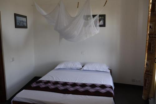 a bedroom with a bed with a mosquito net at Themi View in Arusha