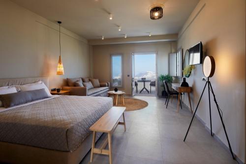 a bedroom with a bed and a living room at Mayu Suites in Pyrgos