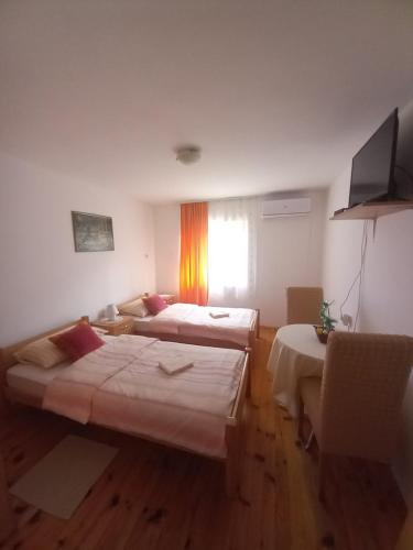 a hotel room with two beds and a couch at Soba Dujaković in Banja Vrućica