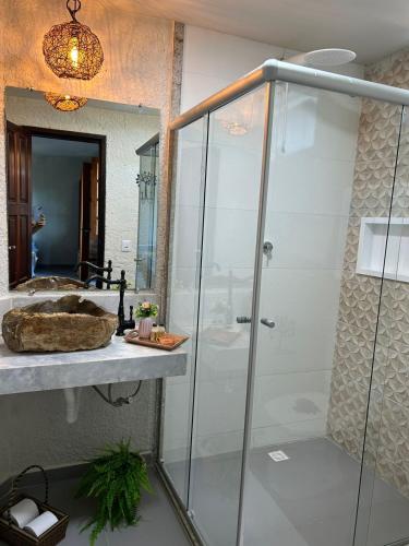 a bathroom with a glass shower and a sink at Pousada Preciosa do Arraial - com Natura e L'Occitane - recém inaugurada in Arraial d'Ajuda