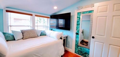 a bedroom with a white bed and a window at The Beachy Bungalow w/King Bed, near Dtwn & Beach in St. Petersburg