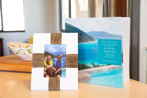 a book stand on a table with a picture of a couple at Jost Van Dyke, BVI 3 Bedroom Villa with Caribbean Views & Pool in Jost Van Dyke