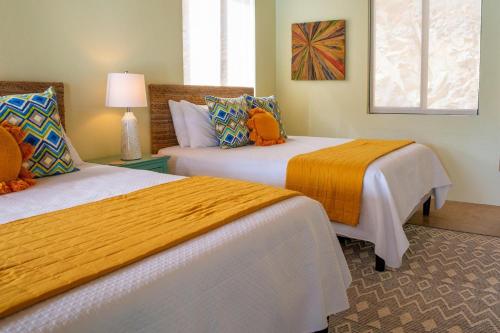 two beds in a hotel room with two beds at Jost Van Dyke, BVI 3 Bedroom Villa with Caribbean Views & Pool in Jost Van Dyke
