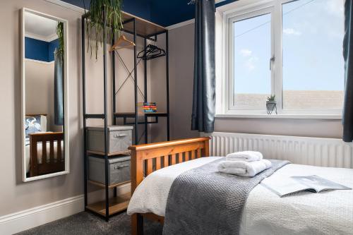 a small bedroom with a bed and a window at The Elderton, Newbiggin By The Sea, Northumberland in Newbiggin-by-the-Sea