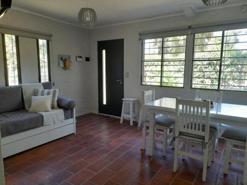 a living room with a couch and a table and chairs at Casa Quinta Las Casuarinas in Mercedes
