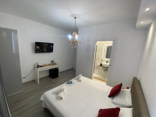 a white room with a couch and a mirror at Zola Centro in Zola Predosa